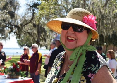 Happy resident at Moosehaven Retirement Community event by the St. Johns River