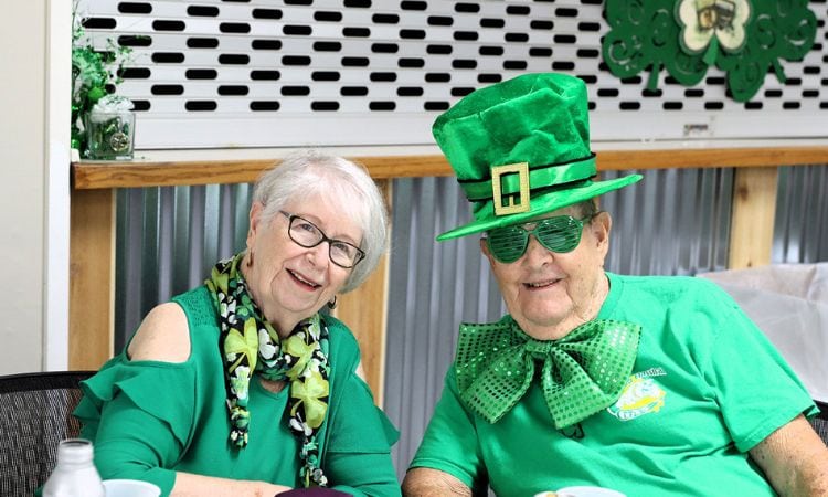 woman wearing green & man dressed as leprechaun