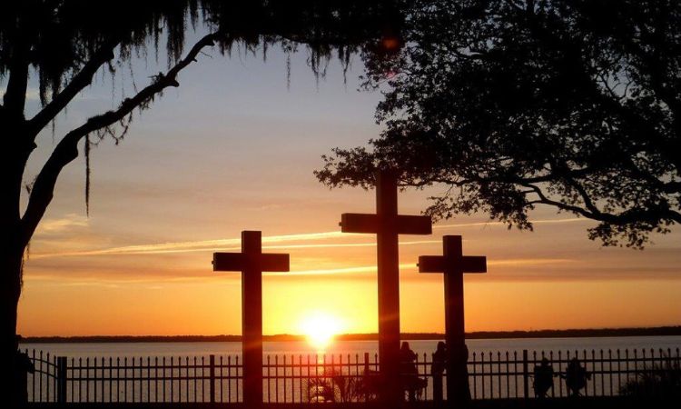 Sunrise over the St. Johns River illuminates 3 crosses