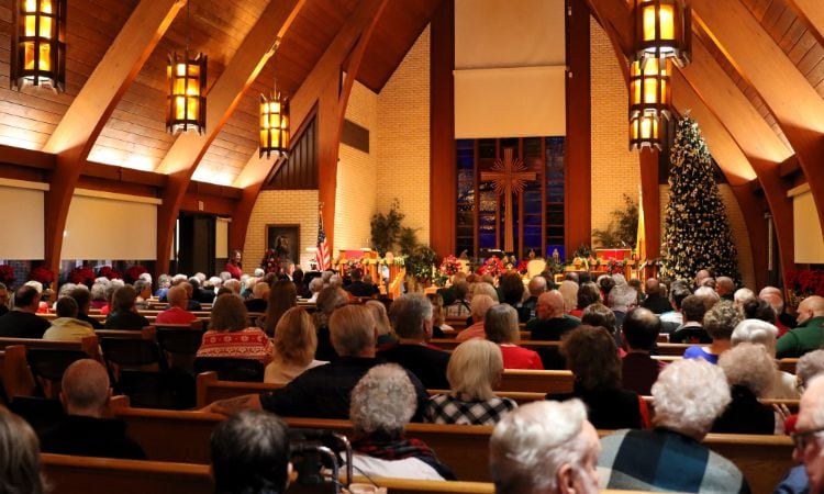 church filled with moosehaven members awaiting tree lighting ceremony